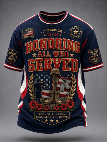 A navy blue short-sleeve t-shirt with a detailed Veterans Day graphic on the front. The graphic features the text 'HONORING ALL WHO SERVED' in red and gold, alongside a patriotic design with an American flag, a kneeling soldier, military boots, and red poppies.