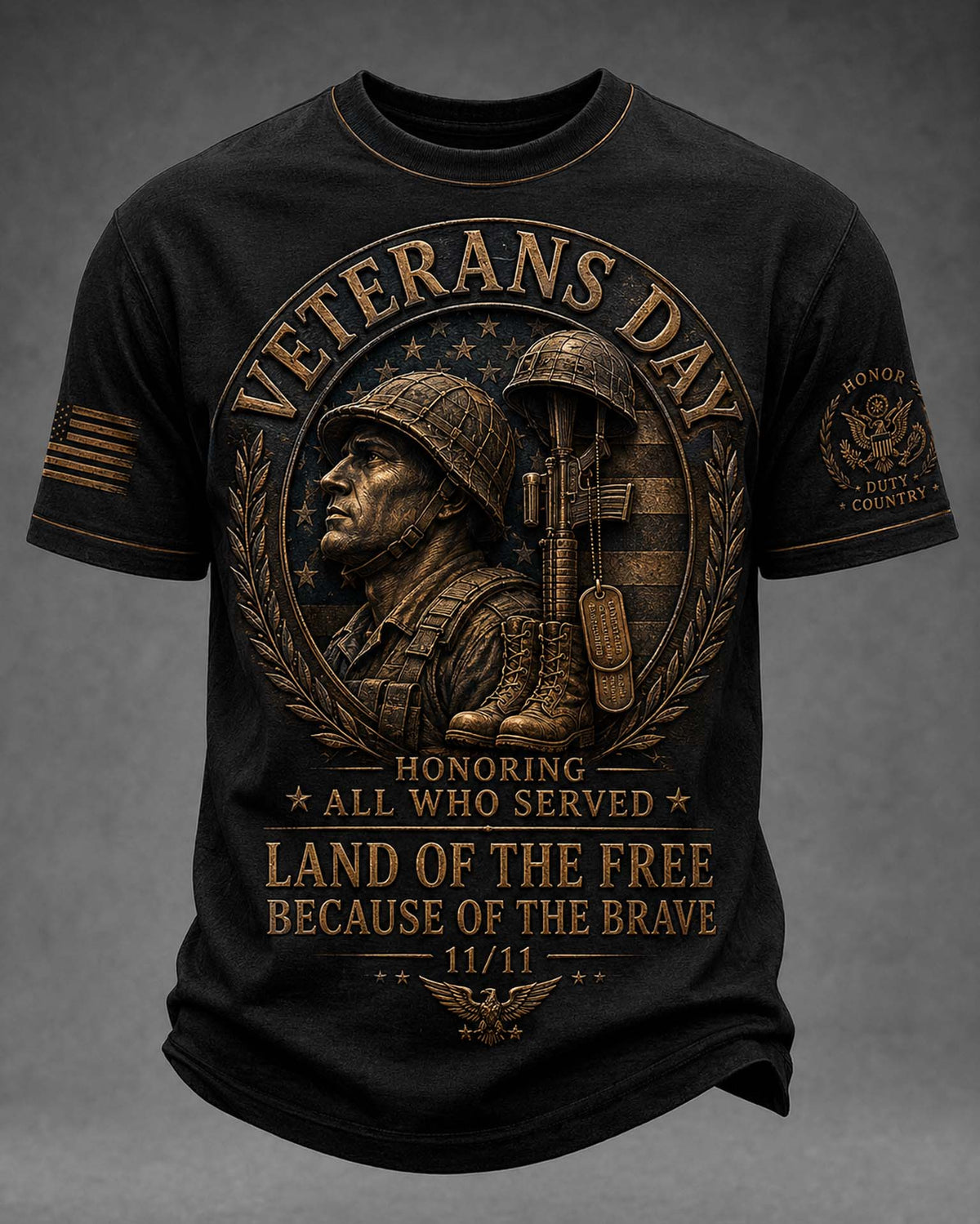 A black short-sleeve t-shirt with a large bronze-colored Veterans Day graphic on the front, featuring a soldier, helmet, rifle, and patriotic text, shown against a dark gray background.