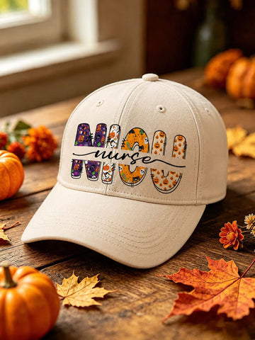 A beige baseball cap with 'NURSE' spelled out in colorful patterned letters, styled on a rustic wooden table with autumn leaves and pumpkins.