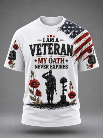White short-sleeve graphic T-shirt with a patriotic veteran design. The front features the text 'I AM A VETERAN MY OATH NEVER EXPIRES' in black and red, with a black soldier silhouette, red poppies, and a distressed American flag on the right shoulder and sleeve.