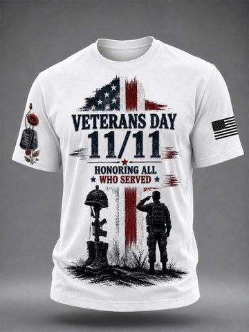 White short-sleeve graphic t-shirt featuring a Veterans Day 11/11 design with an American flag, soldiers, and a military cross, shown on a gray gradient background.