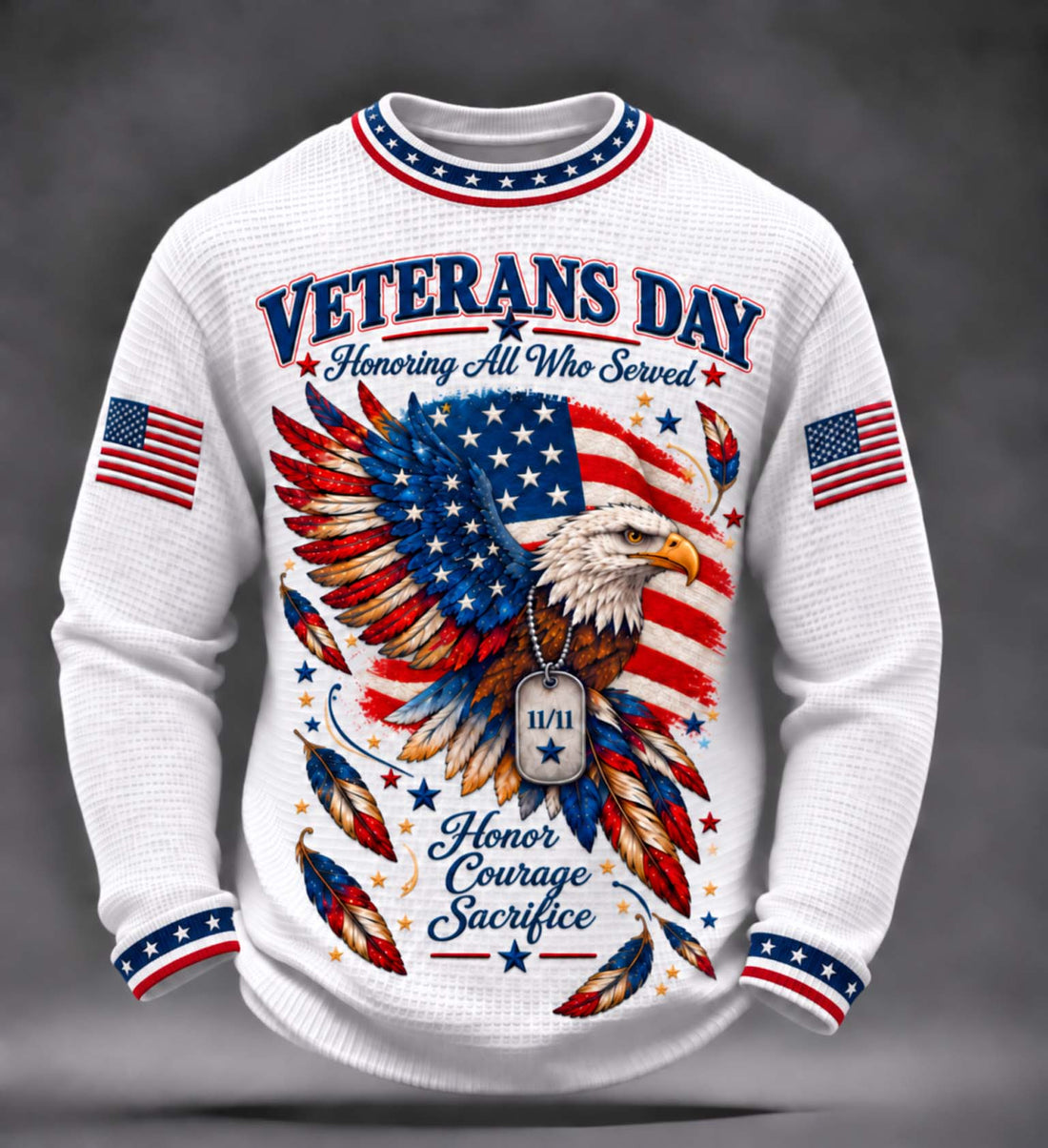 A white waffle-knit long-sleeve crewneck sweater featuring a patriotic Veterans Day graphic. The design includes a bald eagle with an American flag patterned wing, two American flags on the sleeves, and text reading 'VETERANS DAY Honoring All Who Served' and 'Honor Courage Sacrifice'.