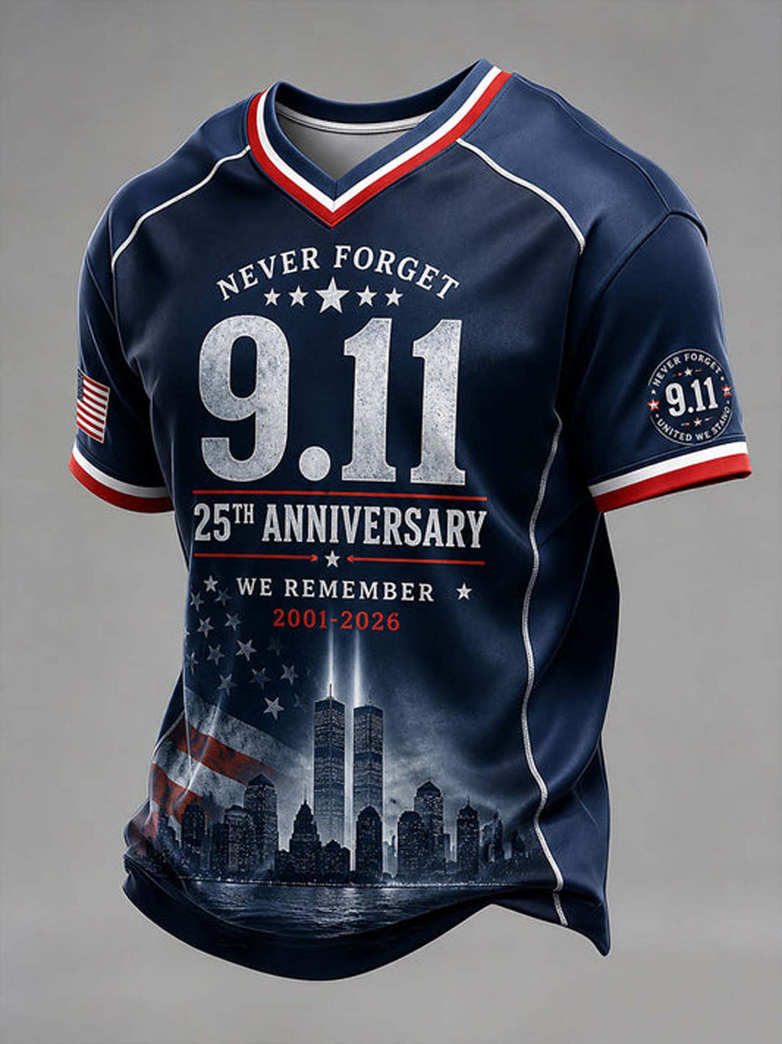 A navy blue short-sleeve V-neck t-shirt with patriotic red and white trim, featuring '9.11' and '25th Anniversary' text, the Twin Towers graphic, and an American flag motif on the sleeves and lower front, shown on a neutral gray background.