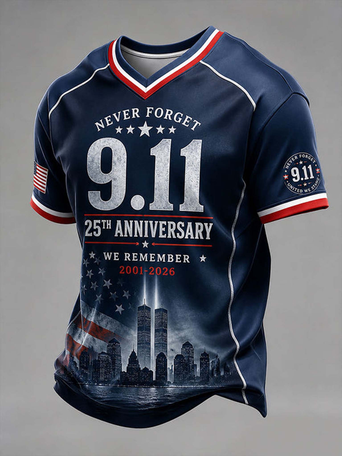 A navy blue short-sleeve V-neck t-shirt with patriotic red and white trim, featuring '9.11' and '25th Anniversary' text, the Twin Towers graphic, and an American flag motif on the sleeves and lower front, shown on a neutral gray background.