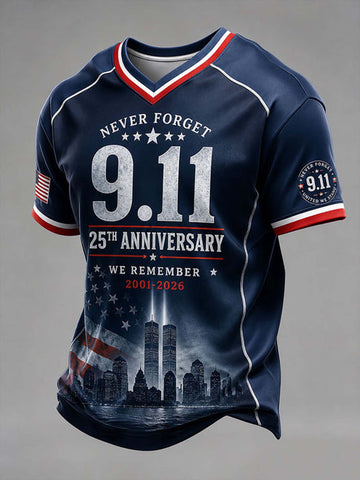 A navy blue short-sleeve V-neck t-shirt with patriotic red and white trim, featuring '9.11' and '25th Anniversary' text, the Twin Towers graphic, and an American flag motif on the sleeves and lower front, shown on a neutral gray background.