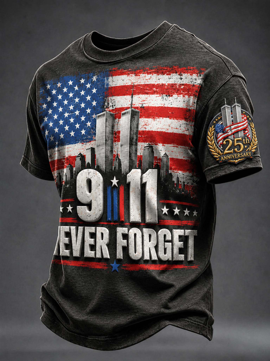 A dark charcoal gray graphic t-shirt featuring a distressed American flag, the 9/11 Twin Towers skyline, '9/11' in large numbers, and 'NEVER FORGET' with a 25th Anniversary sleeve patch.