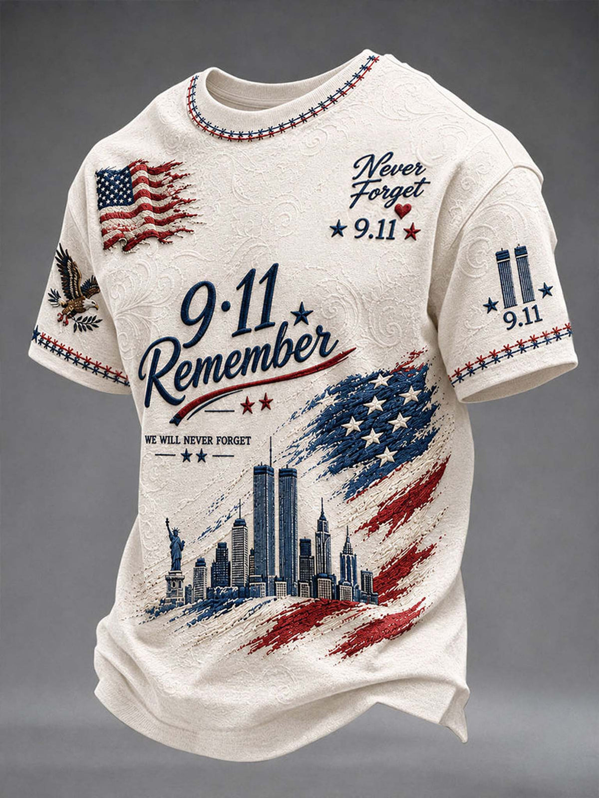 An off-white short-sleeve t-shirt with a textured pattern, featuring a 9/11 memorial graphic with the words 'Never Forget 9.11', '9.