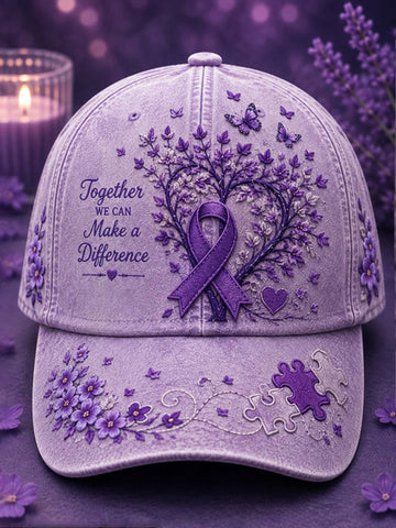 A lavender-purple baseball cap with embroidered purple flowers, butterflies, a ribbon, and the phrase 'Together We Can Make a Difference' on the front, shown against a soft purple background with a blurred candle and lavender sprigs.