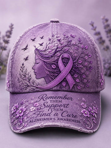 A distressed lavender-purple baseball cap featuring an Alzheimer's awareness design with a profile of a woman, a purple awareness ribbon, leaves, birds, and the text 'Remember them Support them Find a Cure Alzheimer's Awareness' on the brim.