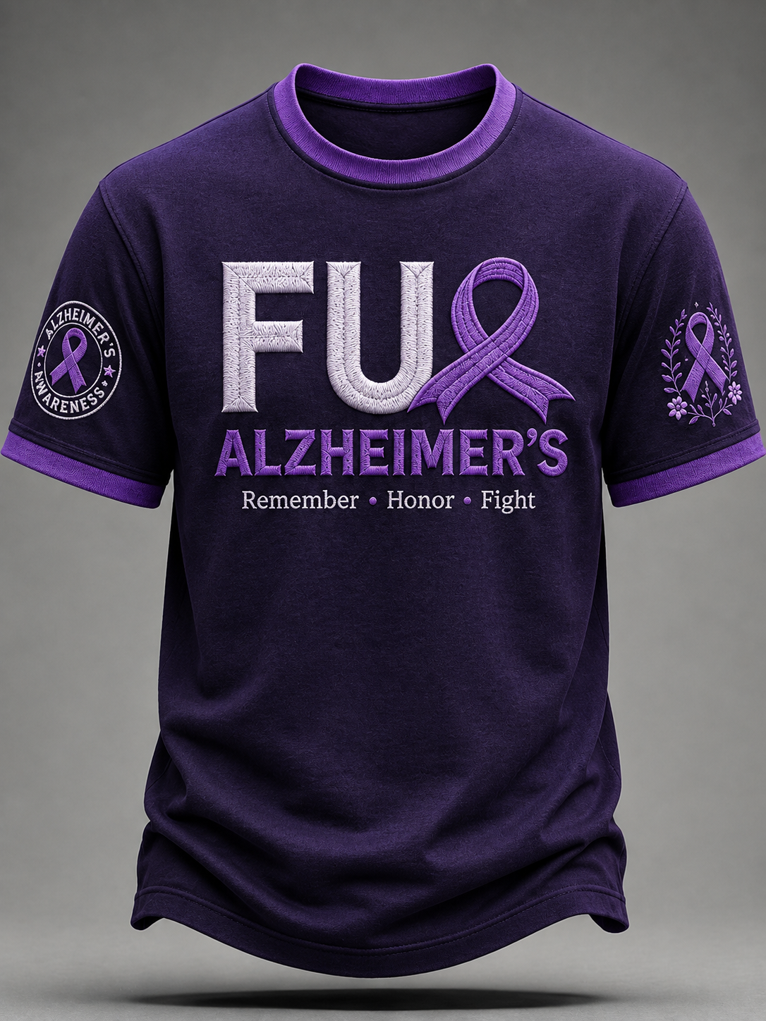 A dark purple short-sleeve t-shirt with a purple and white graphic design on the front reading 'FUL ALZHEIMER'S' with a purple ribbon, and additional text on the sleeves, shown against a neutral gray background.