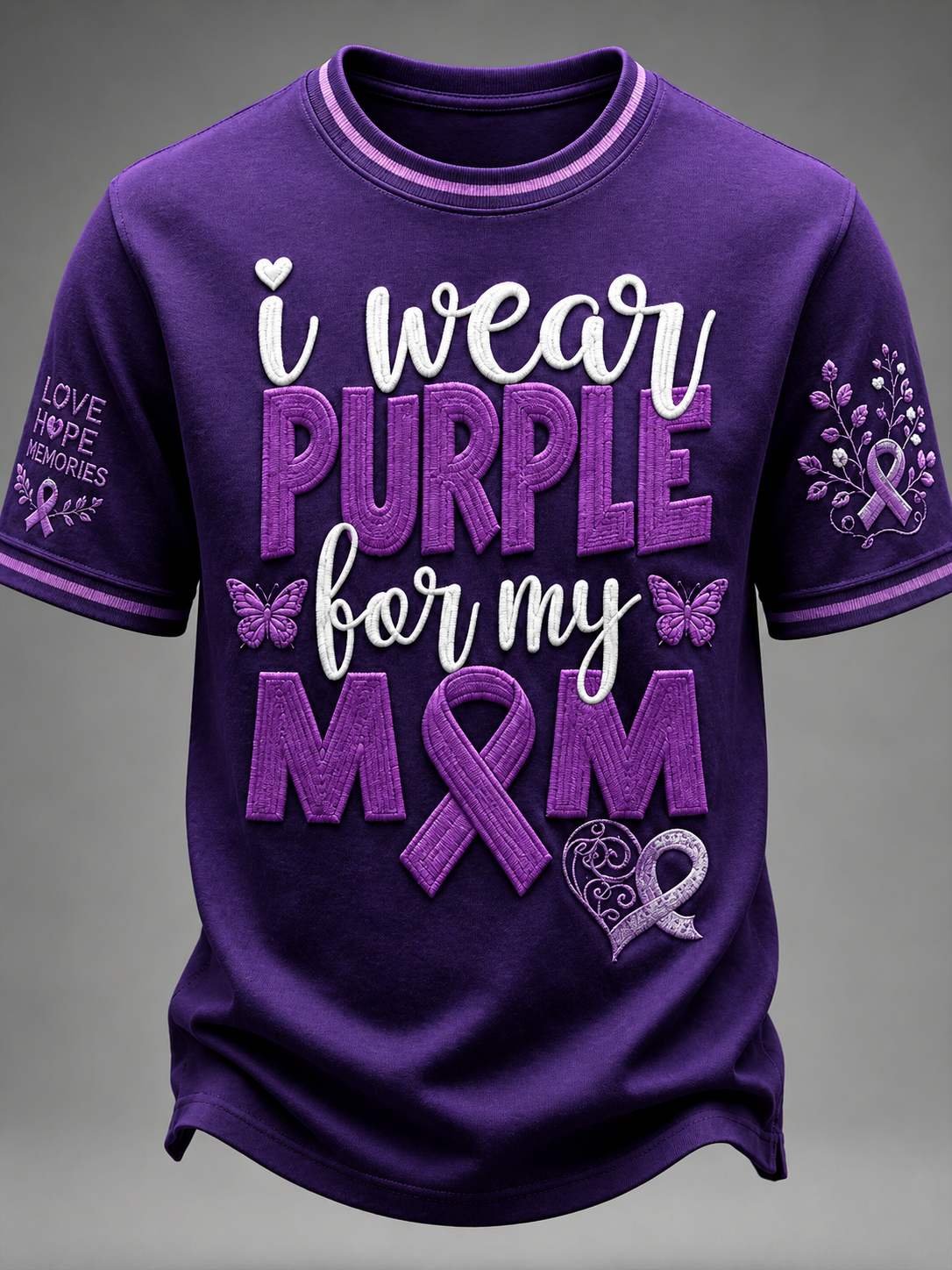 A purple short-sleeve crewneck t-shirt with a graphic that reads 'i wear PURPLE for my MOM' in white and purple lettering, featuring purple awareness ribbons and butterflies. The left sleeve has 'LOVE HOPE PAIN MEMORIES' text with a ribbon, and the right sleeve has a floral ribbon design.
