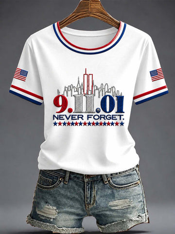 White short-sleeve crewneck T-shirt with red and blue striped collar and sleeve cuffs, featuring a 9/11 memorial graphic with the text '9.11.