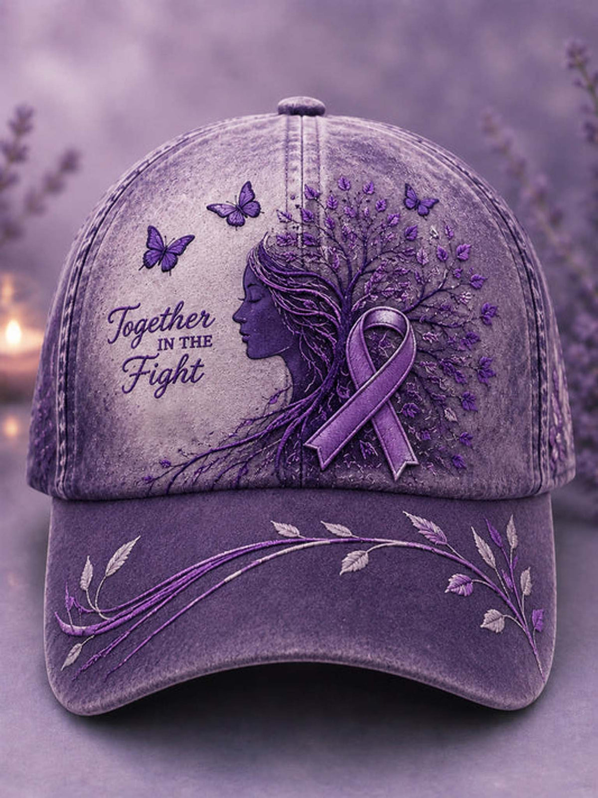 A purple distressed baseball cap featuring a side-profile illustration of a woman whose hair forms a tree with purple leaves and a matching awareness ribbon. The cap includes the text 'Together in the Fight' along with butterflies and floral embroidery on the brim, set against a soft blurred lavender background.