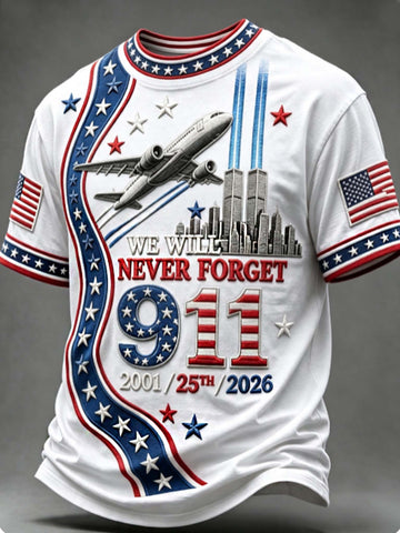 A white short-sleeve t-shirt with a patriotic 9/11 memorial graphic. The design features red and blue stripes, white stars, the text 'WE WILL NEVER FORGET 9/11 2001/25th/2026', an airplane flying above the Twin Towers, and American flags on both sleeves.