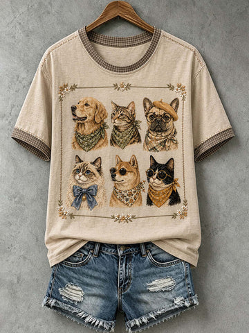 A beige graphic t-shirt with a dog print, styled with distressed denim shorts on a wooden hanger against a gray textured wall.