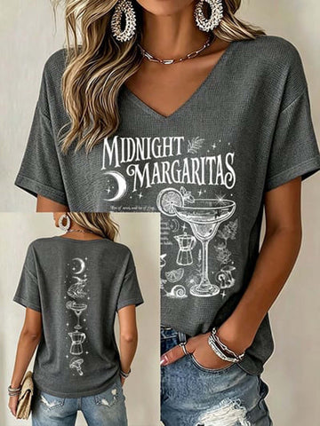 A woman wearing a dark gray heather V-neck t-shirt with a white 'Midnight Margaritas' graphic print on the front, shown in a multi-view collage including front, back, and side details.