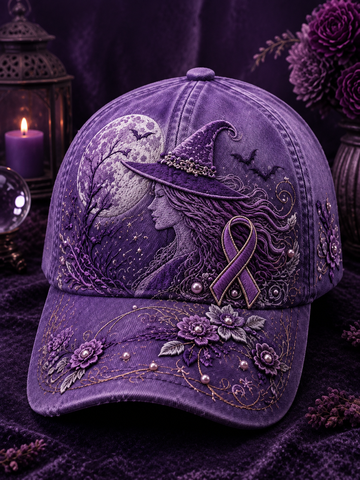 A purple embroidered baseball cap featuring a witch's hat, a profile portrait, a purple awareness ribbon, bats, and floral details, displayed on a dark purple velvet surface with candles and flowers in the background.